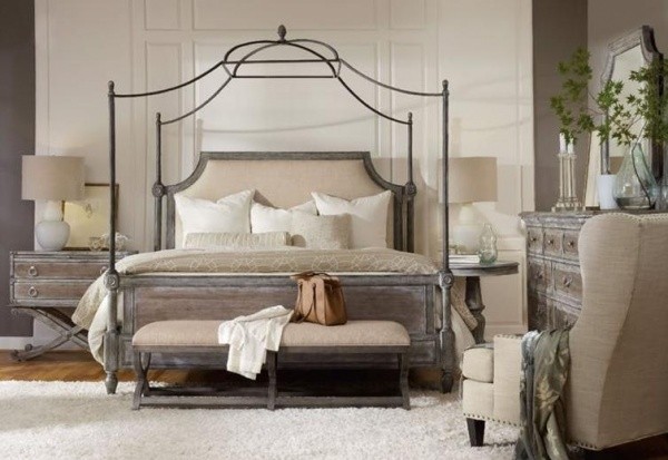 luxury home furniture master bedroom with grey and brown canopy bed with antiqued wooden furniture